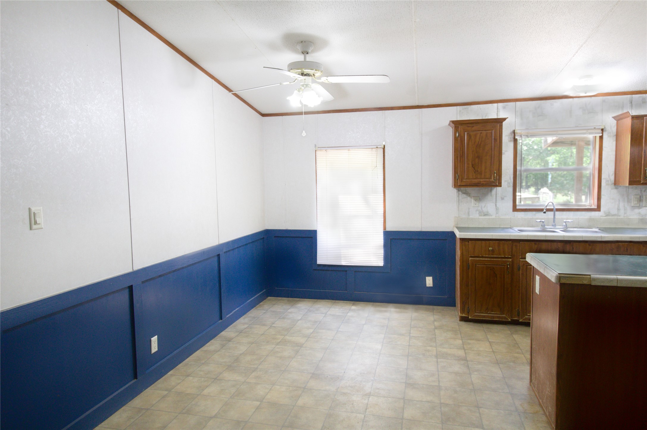 27894 East River Road Splendora, TX 77372 - Photo 9 of 12 a kitchen with wooden cabinets and a sink