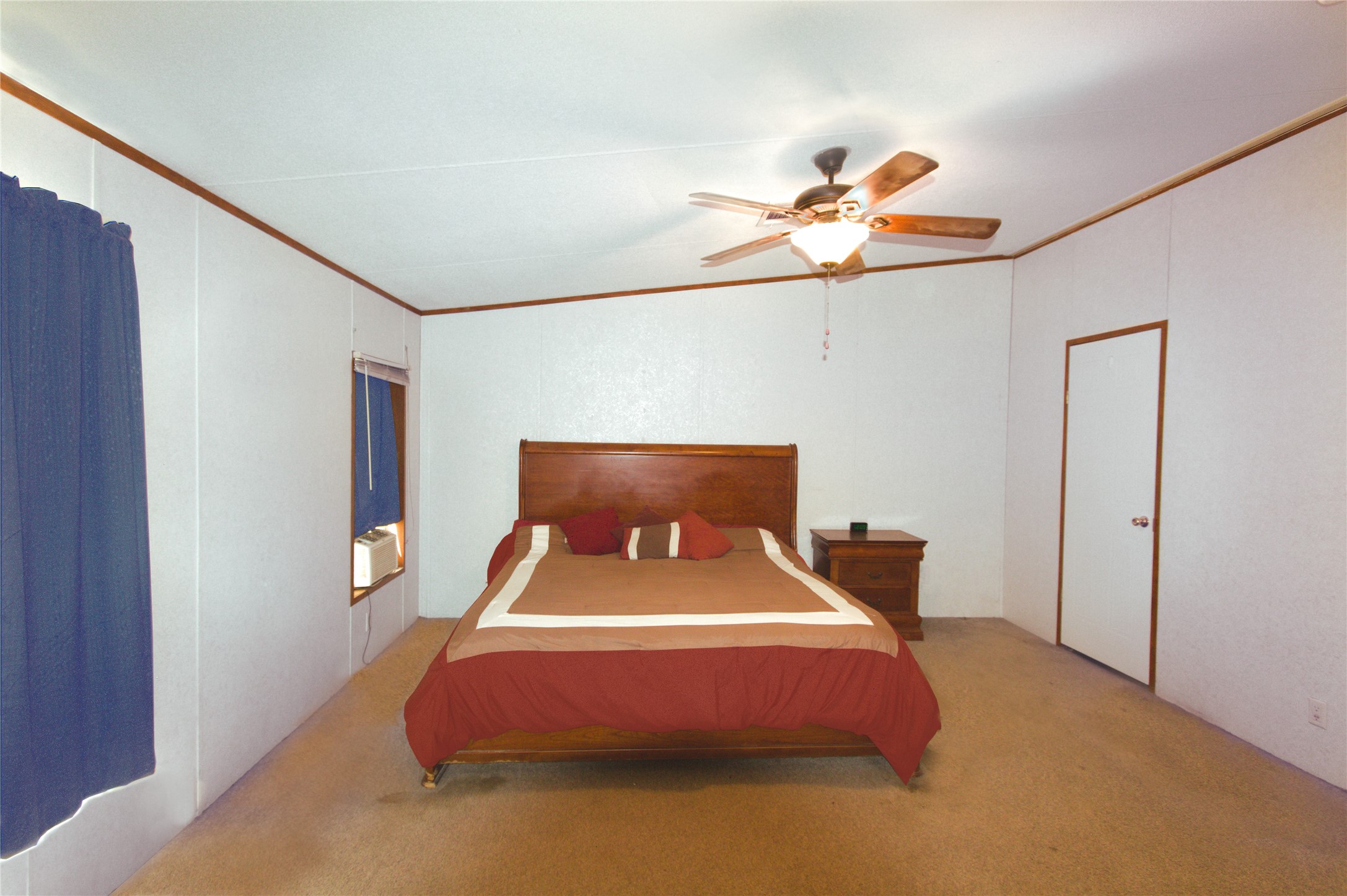 27894 East River Road Splendora, TX 77372 - Photo 10 of 12 a bedroom with a bed and a chandelier