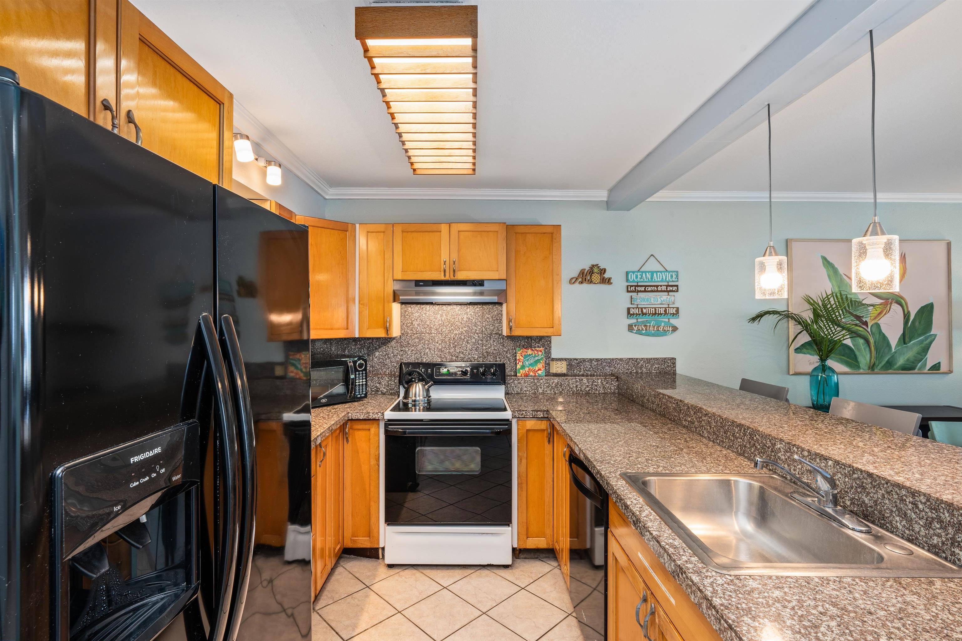 3615 Lower Honoapiilani Road, Unit 123 Lahaina, HI 96761 - Photo 24 of 41 a kitchen with stainless steel appliances granite countertop a sink stove and refrigerator