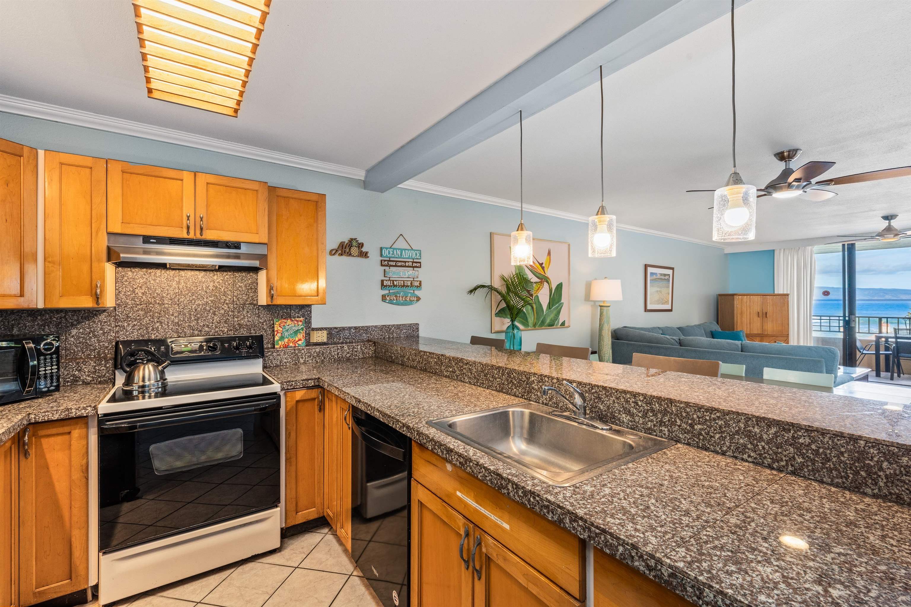 3615 Lower Honoapiilani Road, Unit 123 Lahaina, HI 96761 - Photo 25 of 41 a kitchen with granite countertop a sink a counter space appliances and cabinets