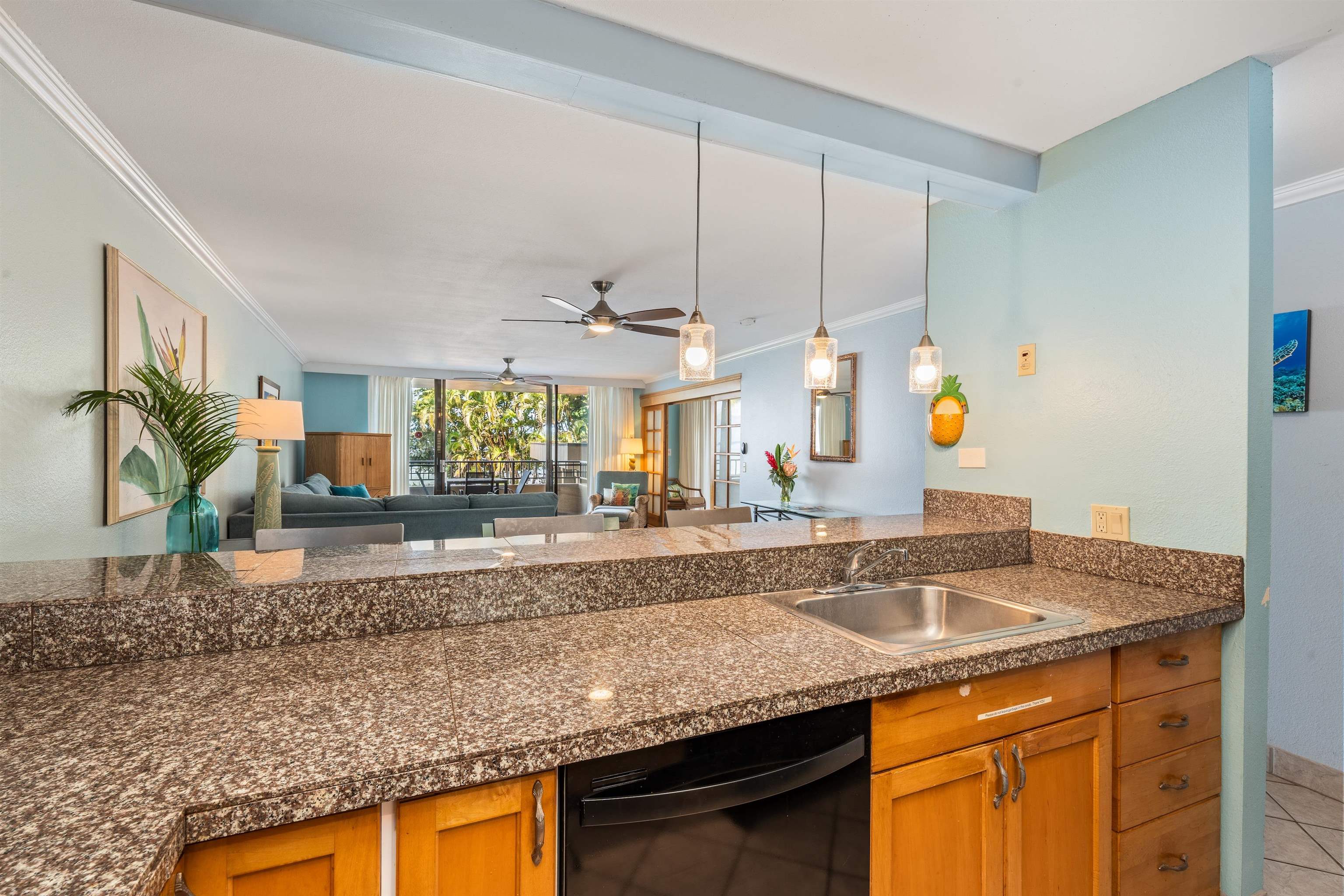 3615 Lower Honoapiilani Road, Unit 123 Lahaina, HI 96761 - Photo 26 of 41 a kitchen with stainless steel appliances granite countertop a sink a stove and a microwave