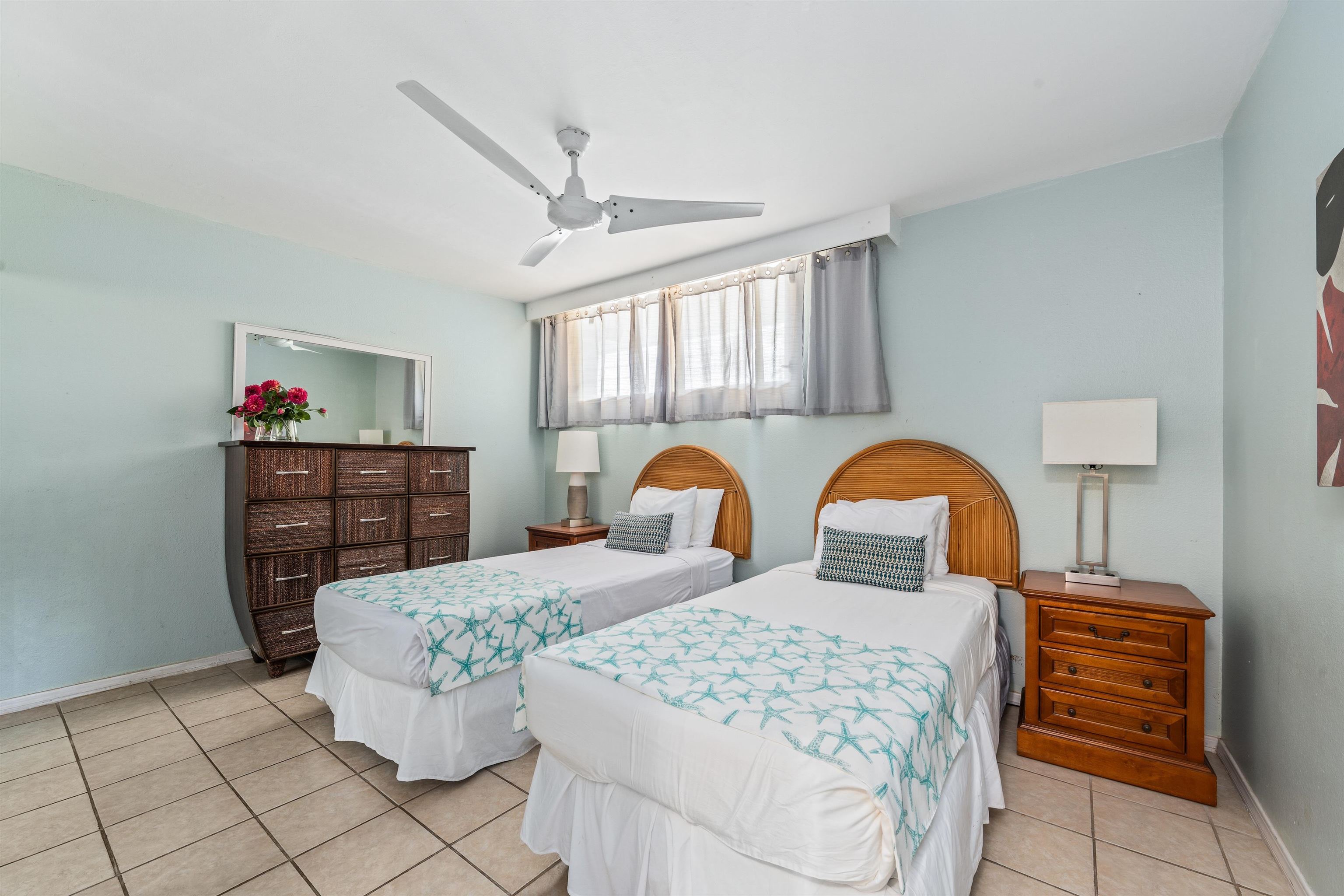 3615 Lower Honoapiilani Road, Unit 123 Lahaina, HI 96761 - Photo 33 of 41 a bedroom with a bed and dresser with mirror