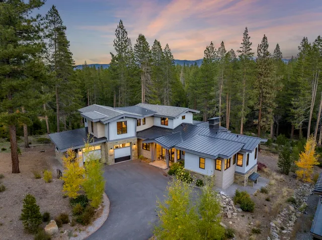 an aerial view of a house with yard patio and green space
