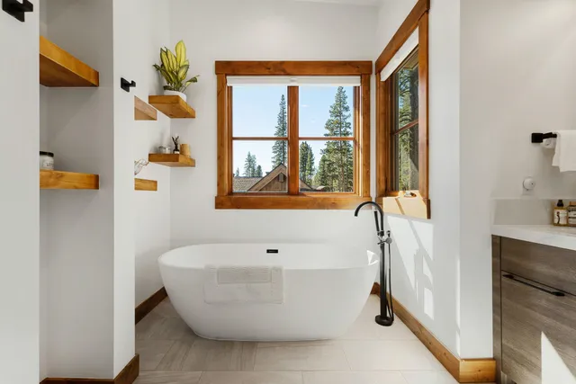 a white bath tub sitting next to a bathroom