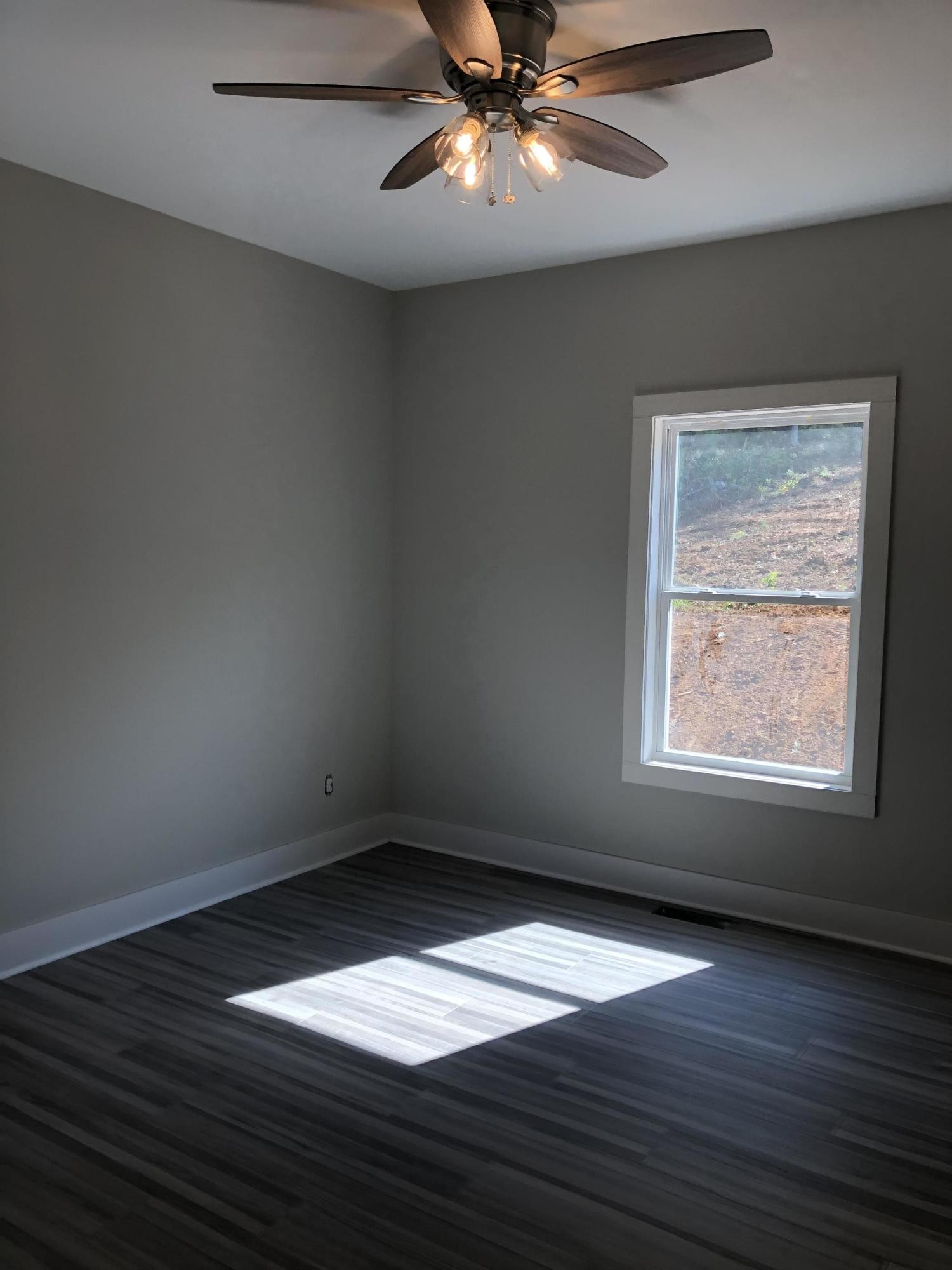 255 Clear Creek Road Kodak, TN 37764 - Photo 8 of 8 en empty room with wooden floor and windows