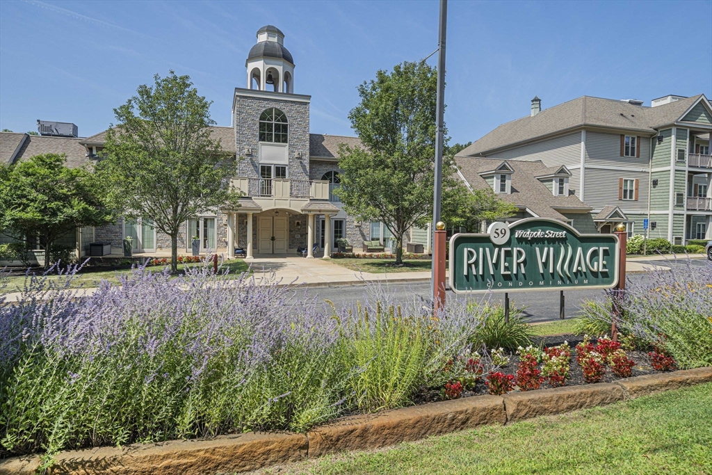 a front view of a house with a yard and garden