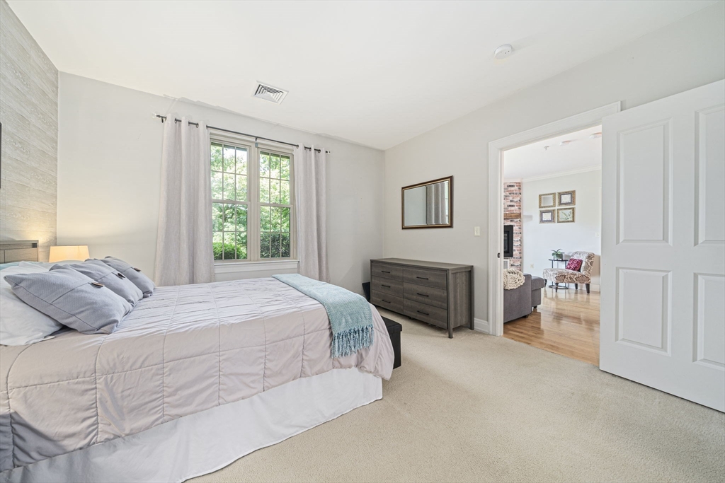 59 Walpole Street, Unit 115 Canton, MA 02021 - Photo 12 of 41 a bedroom with a bed and a couch