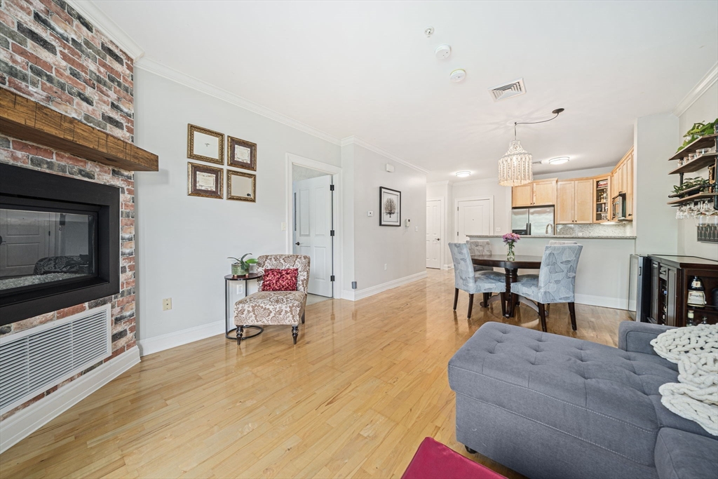 59 Walpole Street, Unit 115 Canton, MA 02021 - Photo 14 of 41 a living room with furniture and a flat screen tv