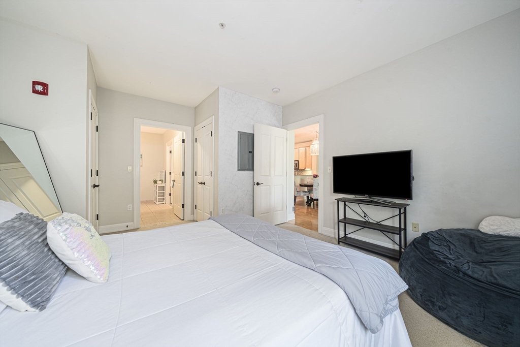 59 Walpole Street, Unit 115 Canton, MA 02021 - Photo 16 of 41 a bedroom with a bed and a flat screen tv