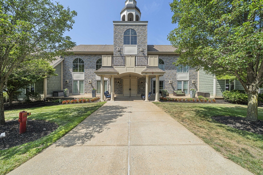 59 Walpole Street, Unit 115 Canton, MA 02021 - Photo 2 of 41 a front view of a house with yard and green space