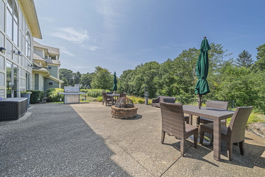 59 Walpole Street, Unit 115 Canton, MA 02021 - Photo 29 of 41 a view of backyard with outdoor seating and plants