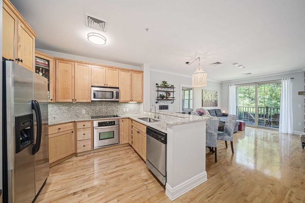 59 Walpole Street, Unit 115 Canton, MA 02021 - Photo 3 of 41 a kitchen with a stove top oven sink and cabinets