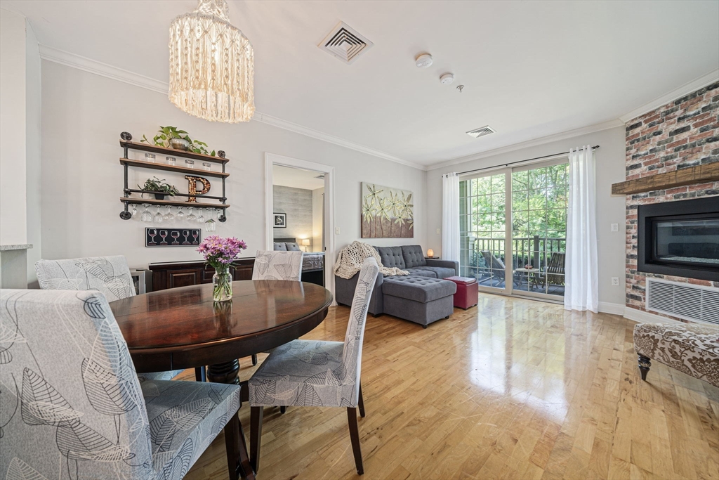 59 Walpole Street, Unit 115 Canton, MA 02021 - Photo 6 of 41 a living room with furniture and a flat screen tv