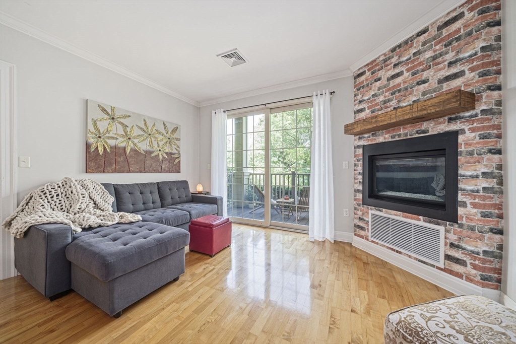 59 Walpole Street, Unit 115 Canton, MA 02021 - Photo 8 of 41 a living room with furniture and a flat screen tv