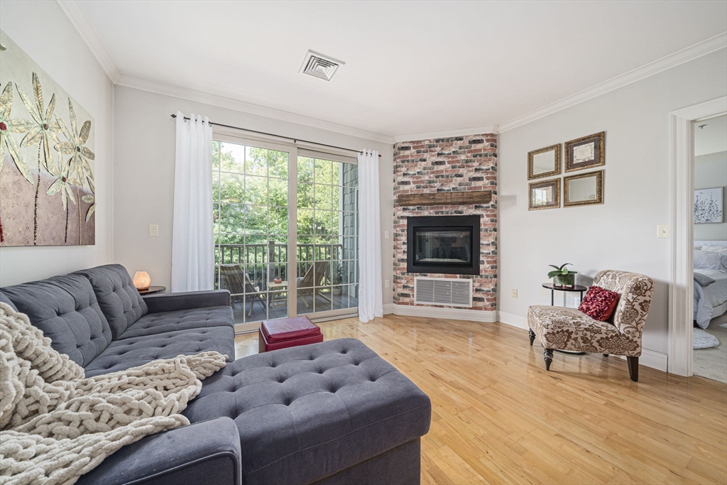 59 Walpole Street, Unit 115 Canton, MA 02021 - Photo 9 of 41 a living room with furniture and a flat screen tv