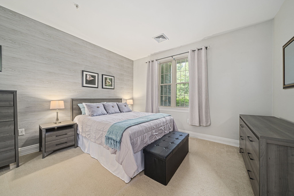59 Walpole Street, Unit 115 Canton, MA 02021 - Photo 10 of 41 a spacious bedroom with a bed and a window