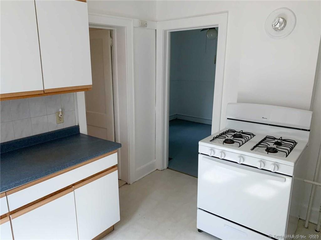 44 Brookside Avenue, Unit U2 Torrington, CT 06790 - Photo 2 of 10 a kitchen with a stove and a microwave