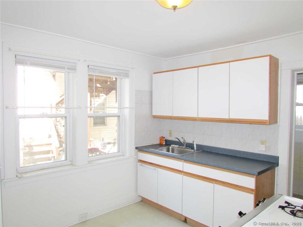 44 Brookside Avenue, Unit U2 Torrington, CT 06790 - Photo 4 of 10 a kitchen with stainless steel appliances cabinets a sink and a window