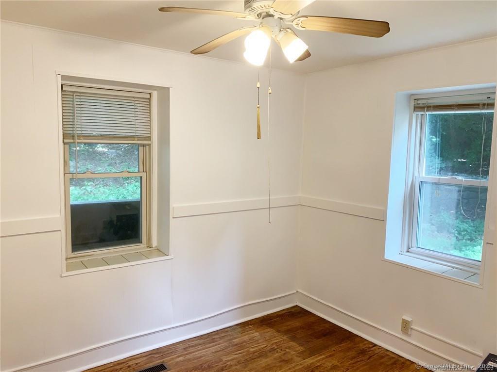 44 Brookside Avenue, Unit U2 Torrington, CT 06790 - Photo 6 of 10 an empty room with a window and chandelier fan
