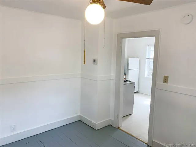 wooden floor in an empty room and a bathroom