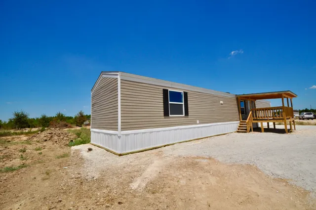 a view of a house with a snow in the yard