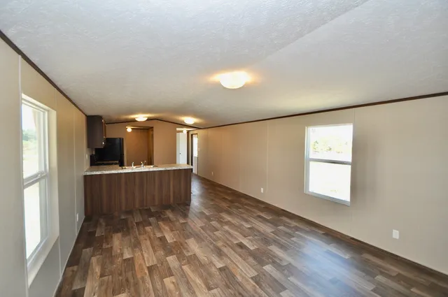 a kitchen with a refrigerator and a stove top oven