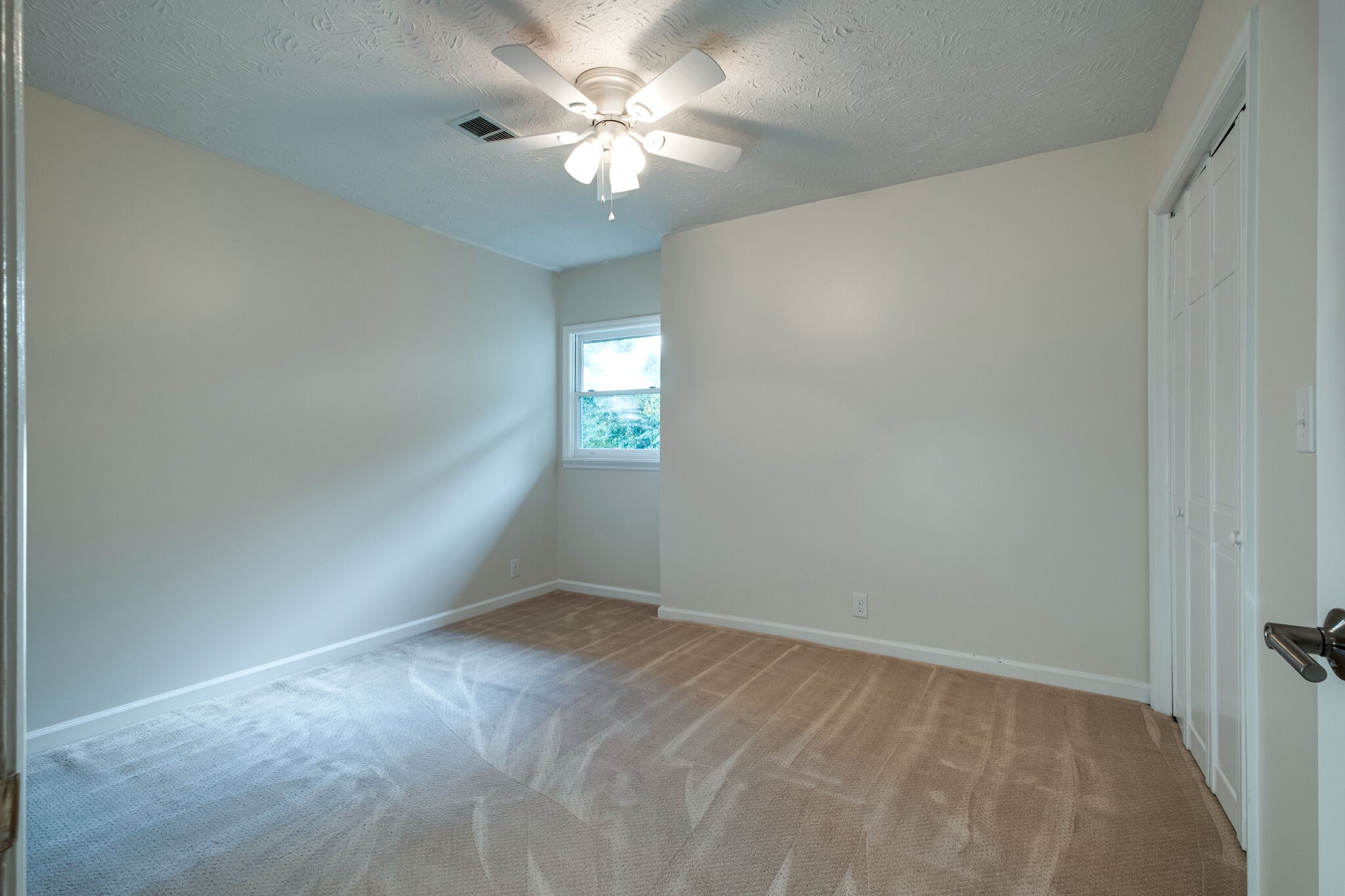1338 Campbell Road Goodlettsville, TN 37072 - Photo 30 of 48 an empty room with a chandelier fan and windows