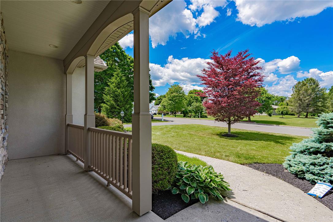 6000 Pond View Terrace Bath, PA 18014 - Photo 12 of 69 A welcoming front porch with manicured landscaping overlooks a tree-lined street.