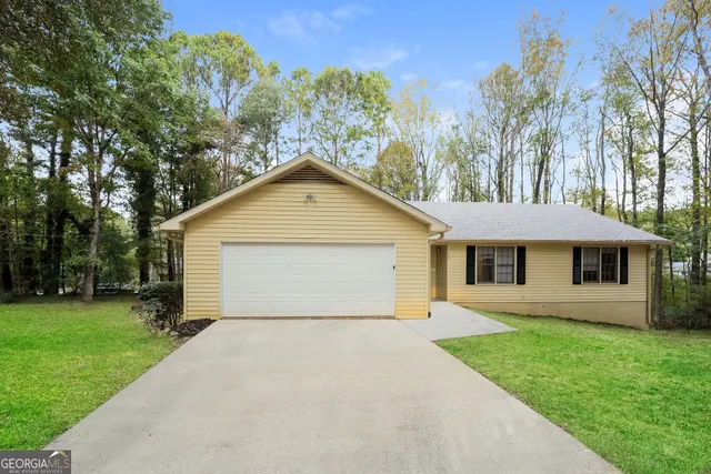 a front view of house with yard and trees