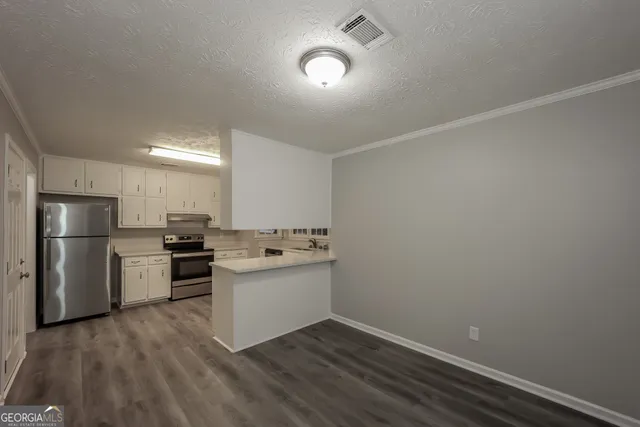 a kitchen with a sink and stainless steel appliances