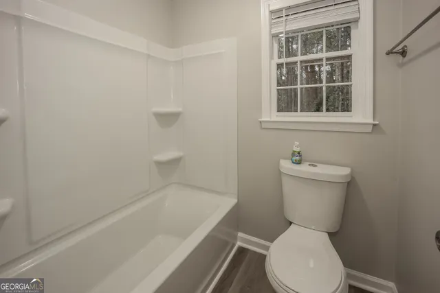 a white toilet sitting next to a bathroom sink