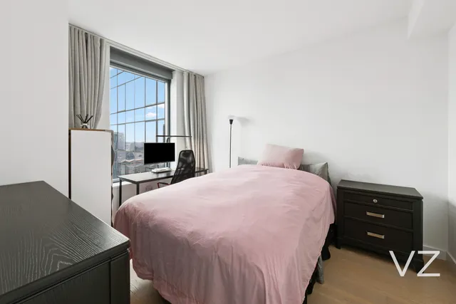 a bedroom with a bed and a table