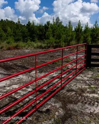 a view of a yard with wooden fence
