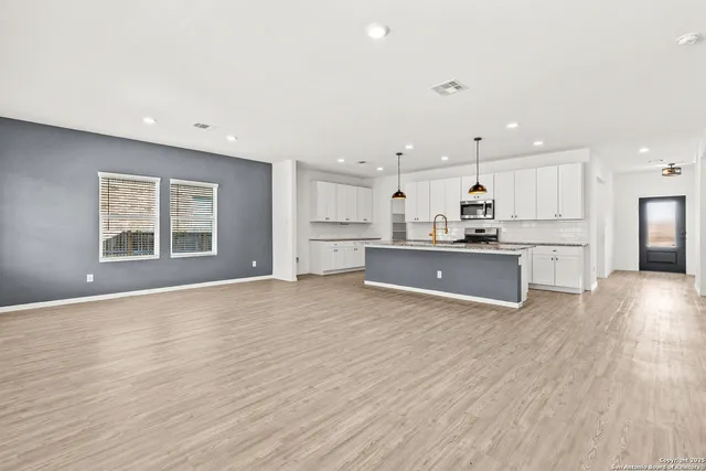 a view of kitchen with wooden floor and windows
