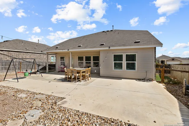a view of a house with wooden roof and sitting space