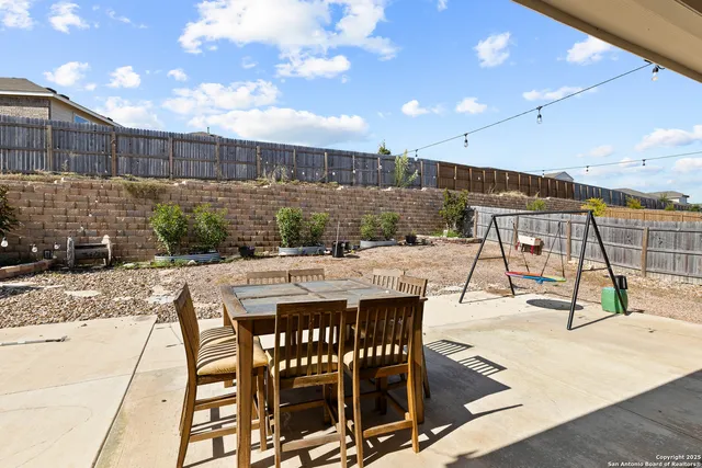 a view of a patio with a table and chairs