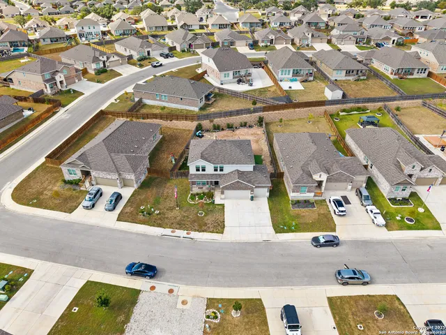 an aerial view of residential houses with outdoor space