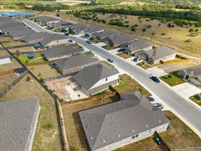 an aerial view of residential houses with outdoor space