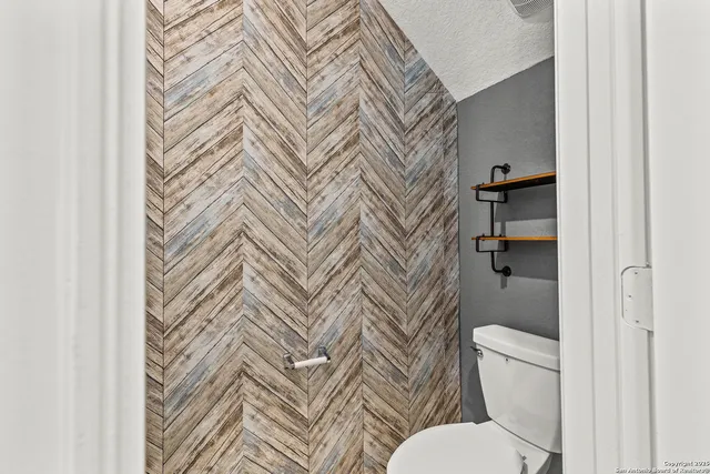 a white toilet sitting next to a shower curtain