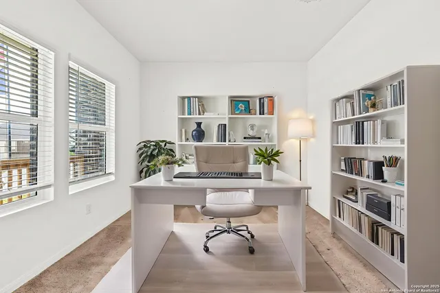 a workspace with furniture and a book shelf