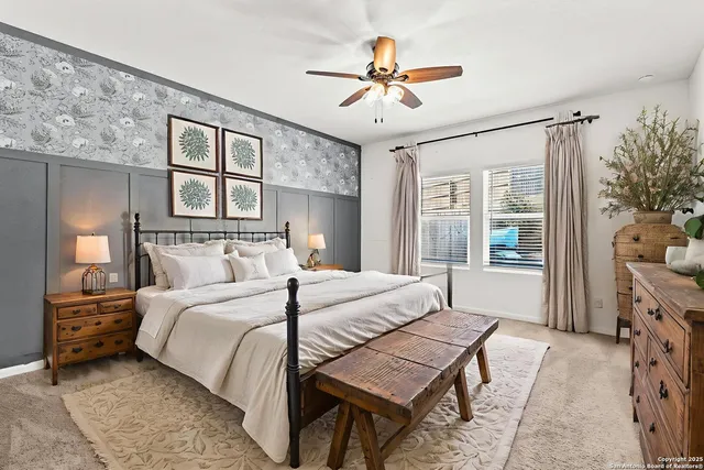a bedroom with a bed chandelier and a window