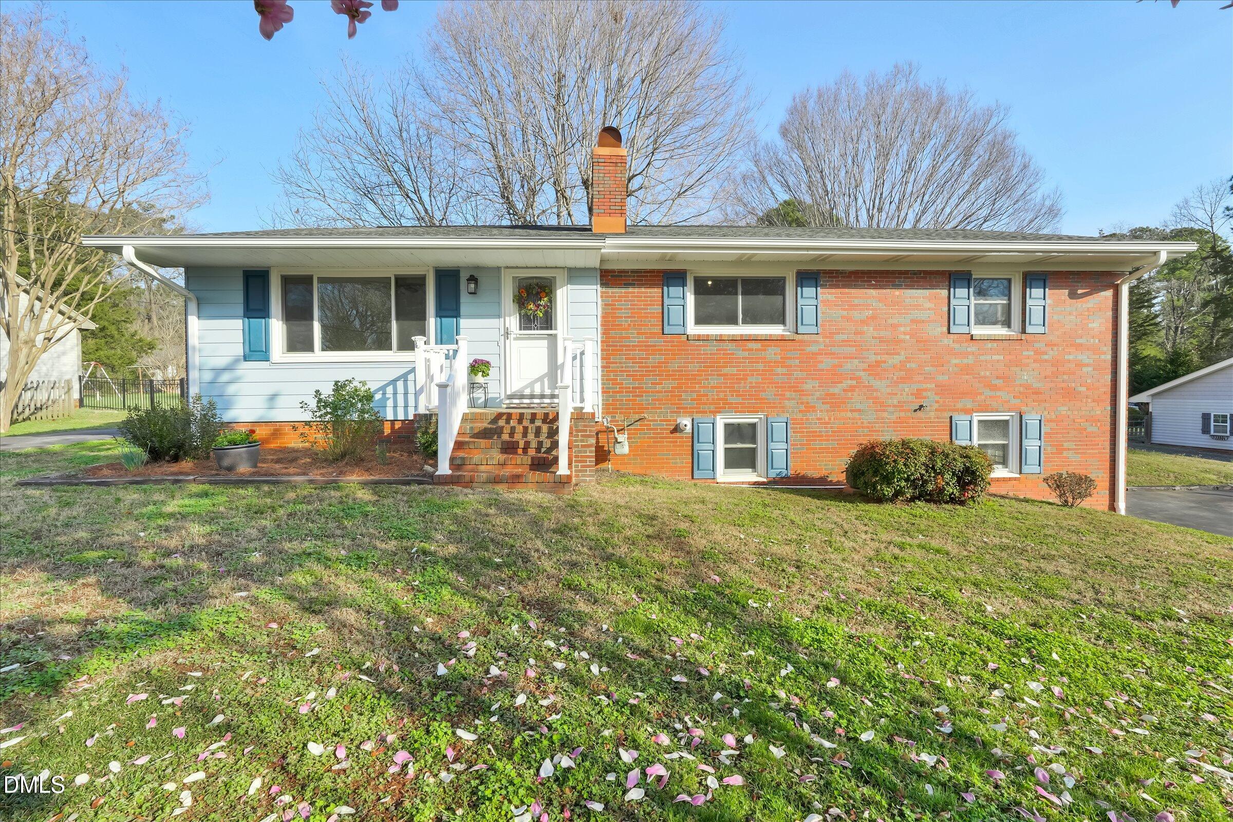 4108 Campbell Road Raleigh, NC 27606 - Photo 1 of 42 a front view of a house with a garden and porch
