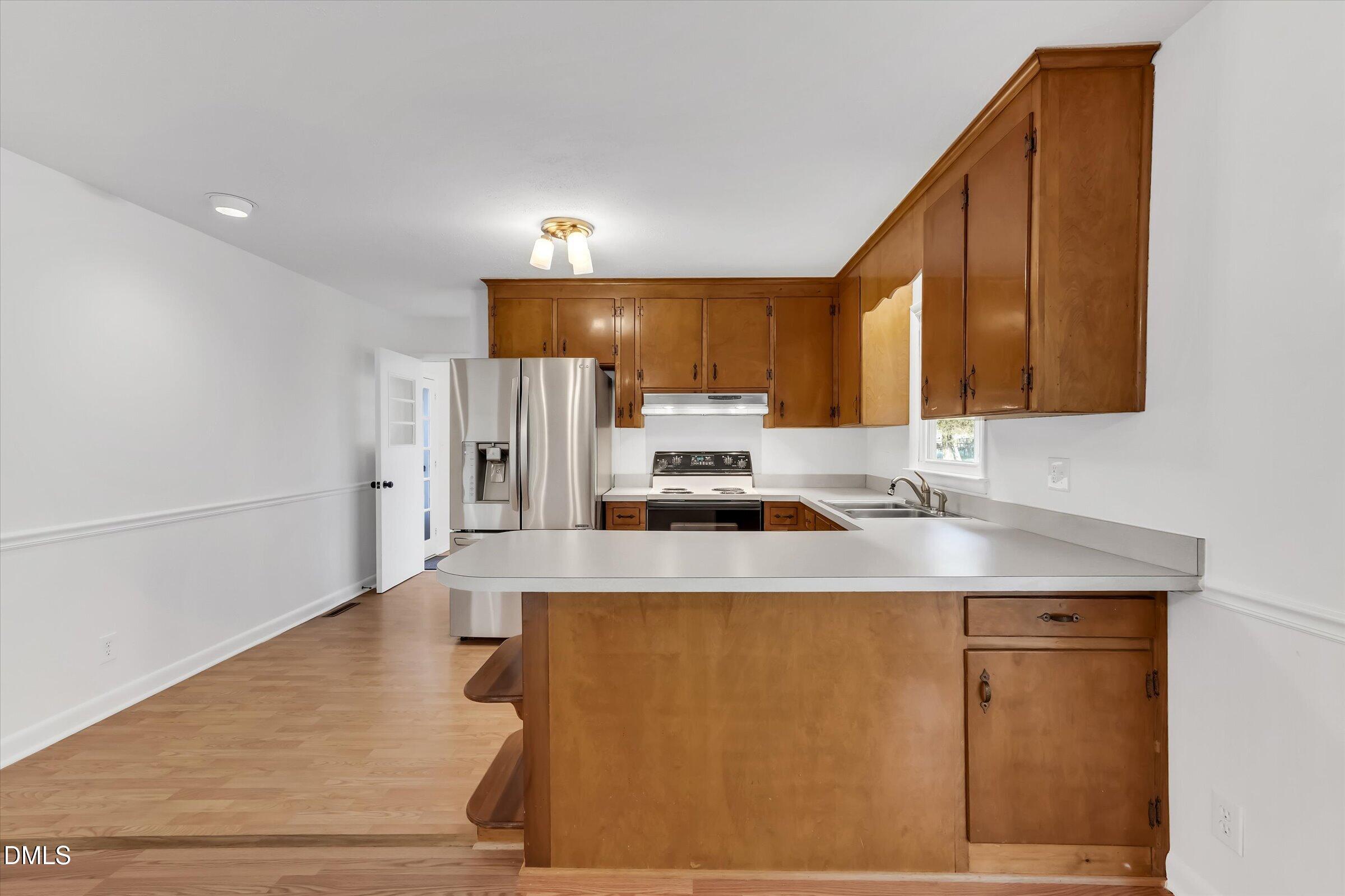 4108 Campbell Road Raleigh, NC 27606 - Photo 10 of 42 a kitchen with stainless steel appliances a sink stove and cabinets
