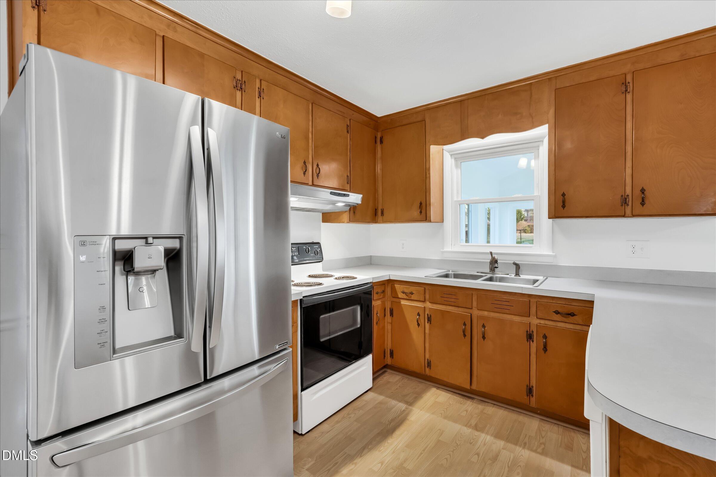 4108 Campbell Road Raleigh, NC 27606 - Photo 12 of 42 a kitchen with stainless steel appliances granite countertop a refrigerator and a sink
