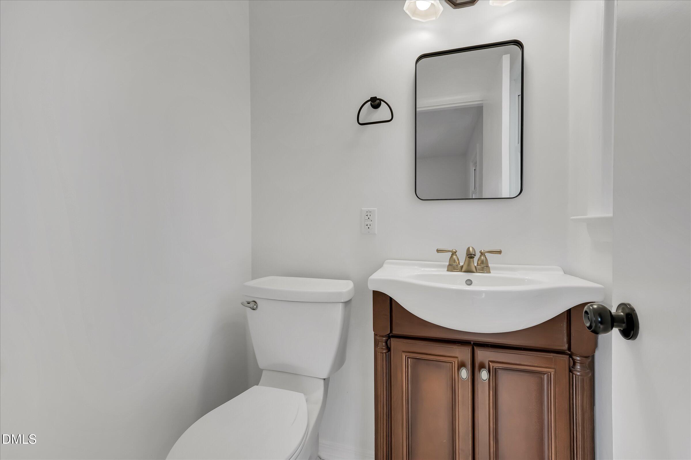 4108 Campbell Road Raleigh, NC 27606 - Photo 17 of 42 a bathroom with a toilet sink and mirror