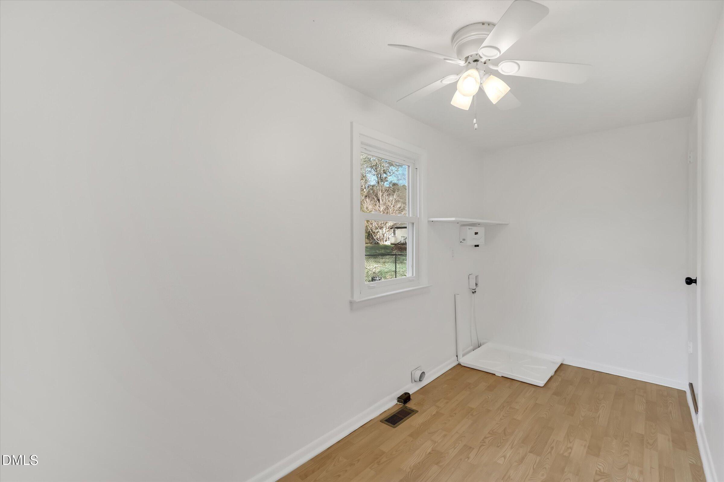 4108 Campbell Road Raleigh, NC 27606 - Photo 19 of 42 an empty room with windows and fan