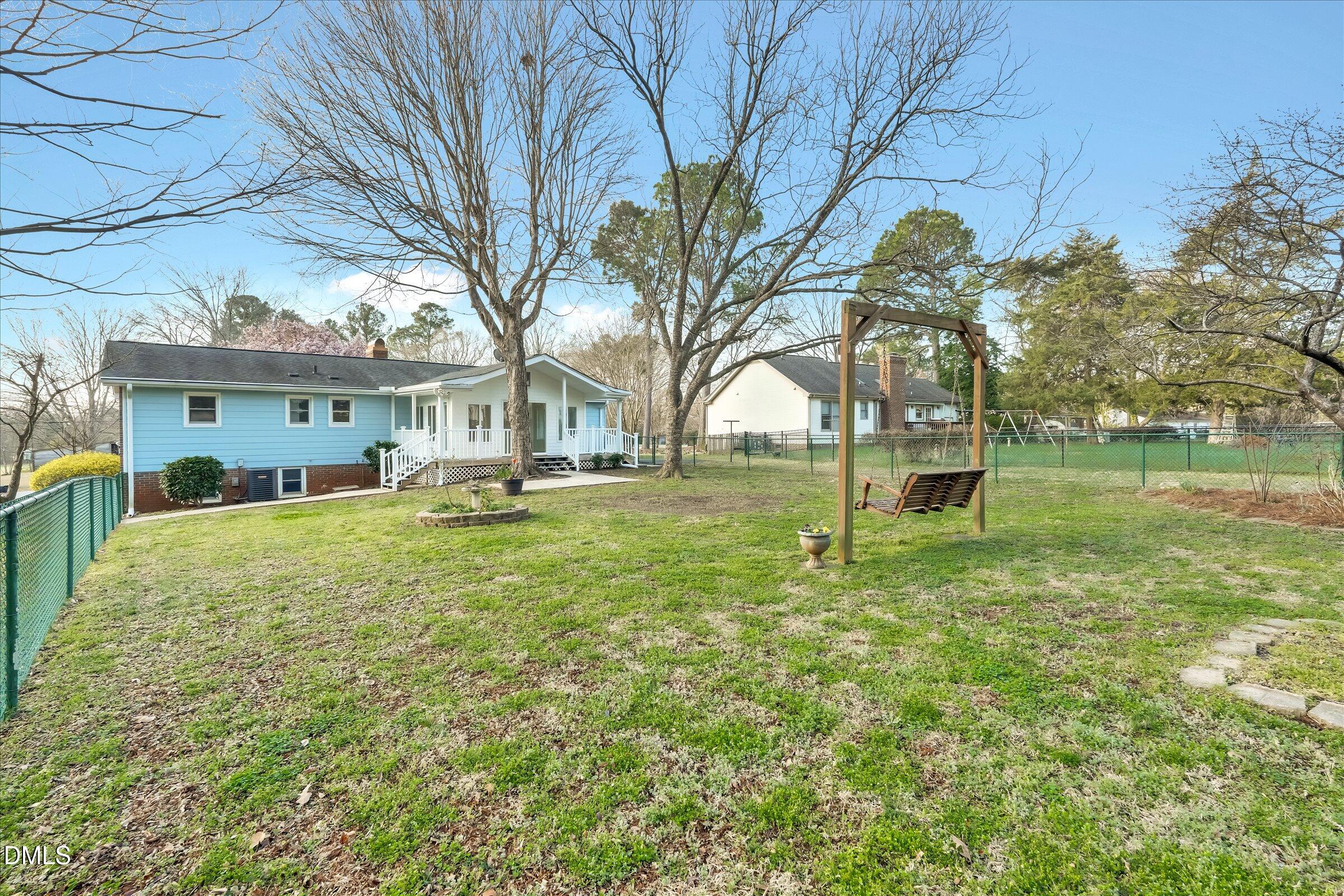 4108 Campbell Road Raleigh, NC 27606 - Photo 25 of 42 a view of a yard with a house and a large tree