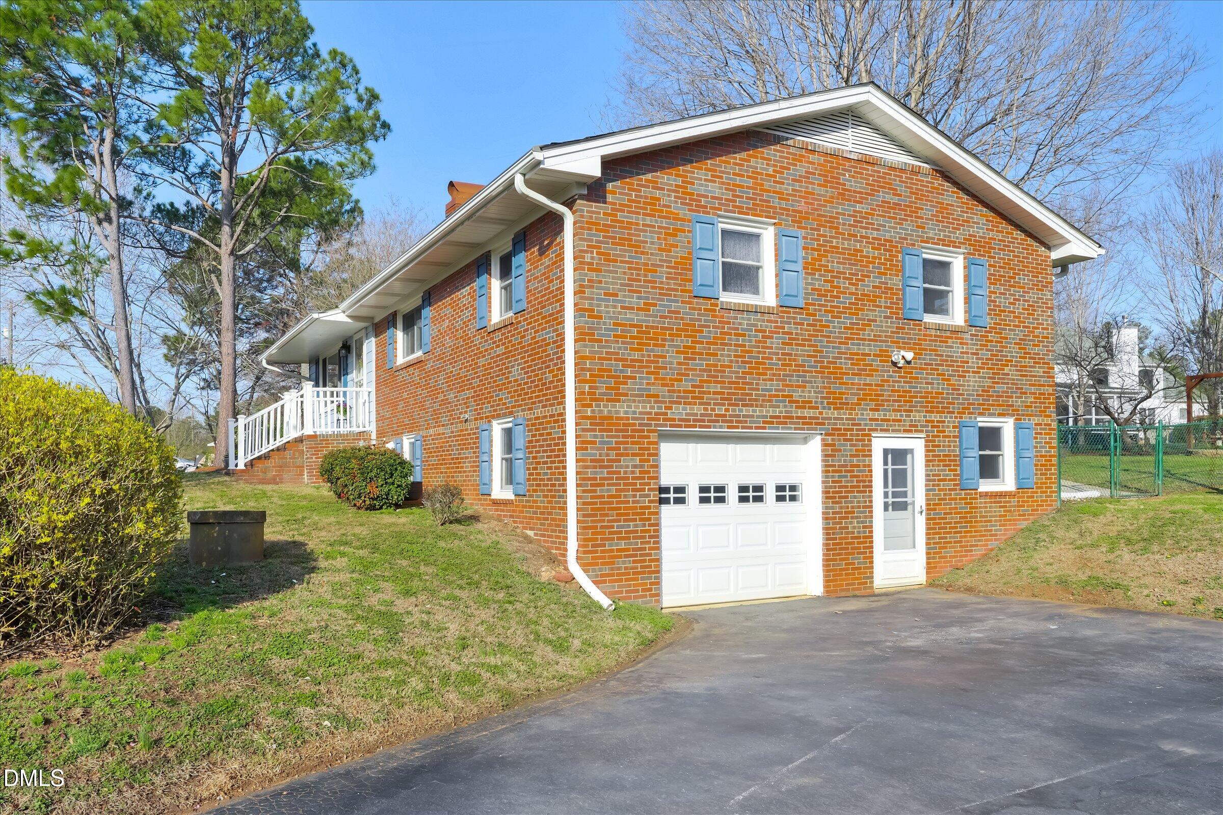 4108 Campbell Road Raleigh, NC 27606 - Photo 3 of 42 a front view of a house with a yard and garage