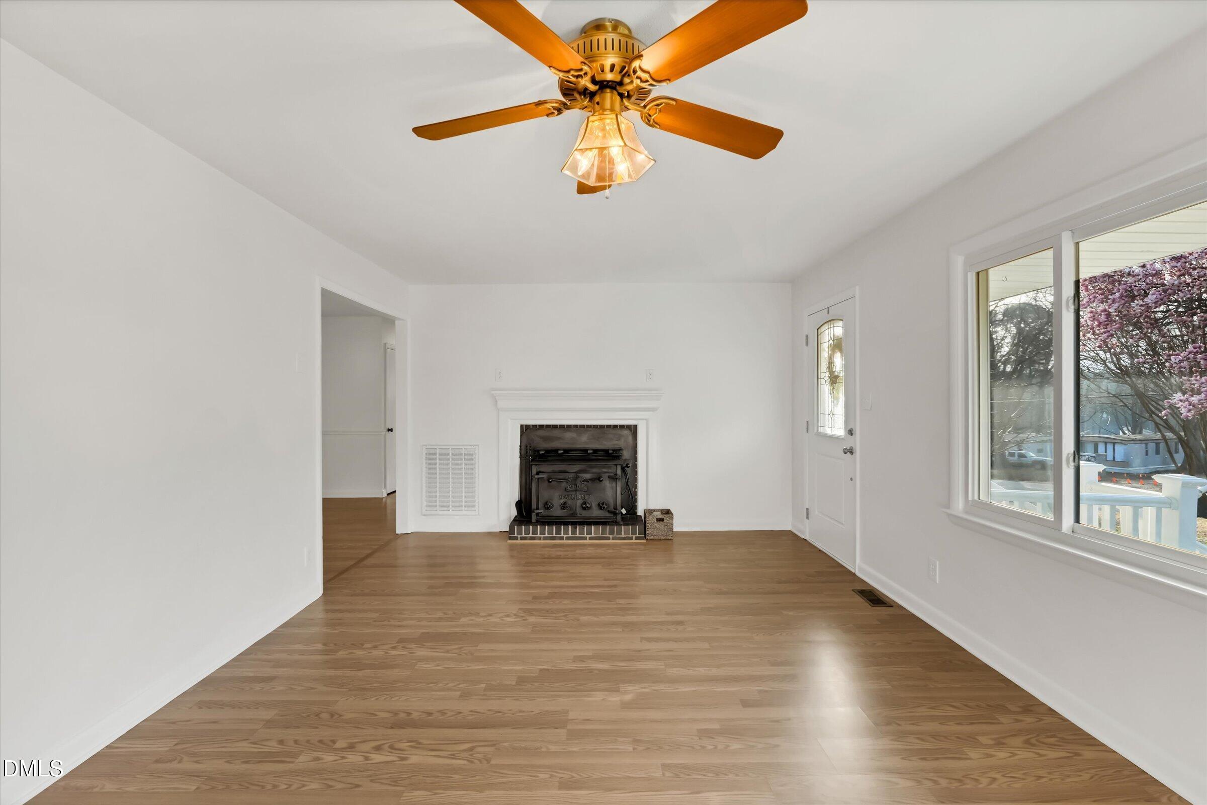 4108 Campbell Road Raleigh, NC 27606 - Photo 6 of 42 an empty room with windows and fan