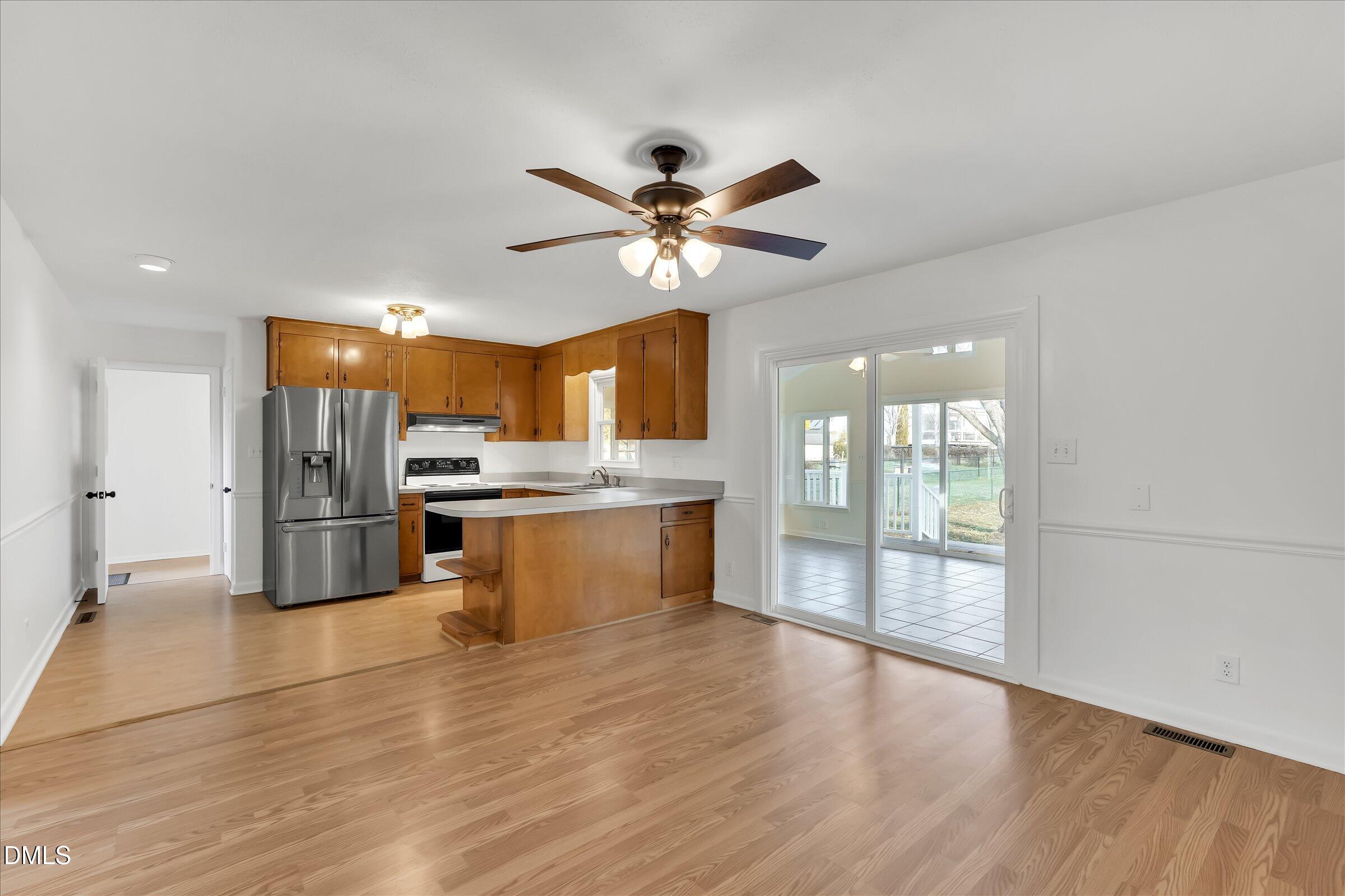 4108 Campbell Road Raleigh, NC 27606 - Photo 8 of 42 a kitchen with stainless steel appliances a refrigerator a sink dishwasher with a stove and refrigerator